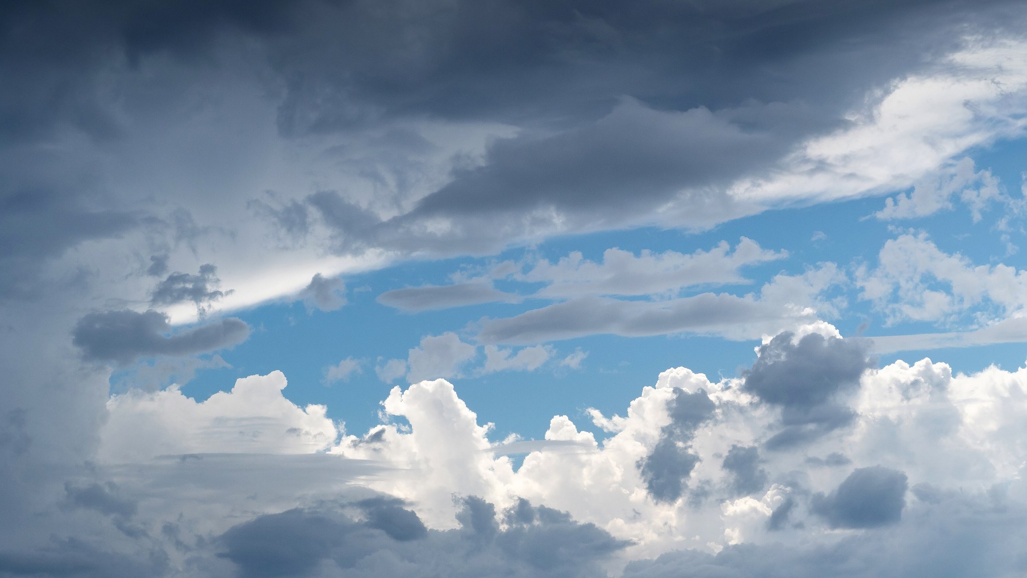 Storm clouds in blue sky, full size